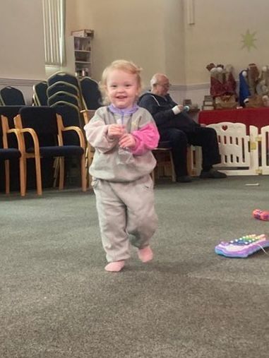 Child smiling during community song group